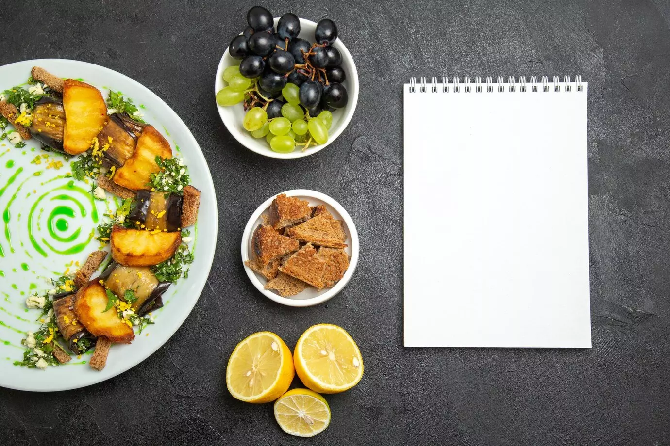 top-view-delicious-eggplant-rolls-with-baked-potatoes-inside-plate-dark-floor-dish-meal-dinner-food-potato-vegetable_140725-116125