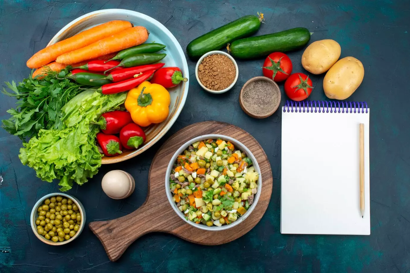 top-view-sliced-vegetable-salad-peppered-with-chicken-slices-inside-plate-with-fresh-vegetables-dark-blue-desk_140725-38930