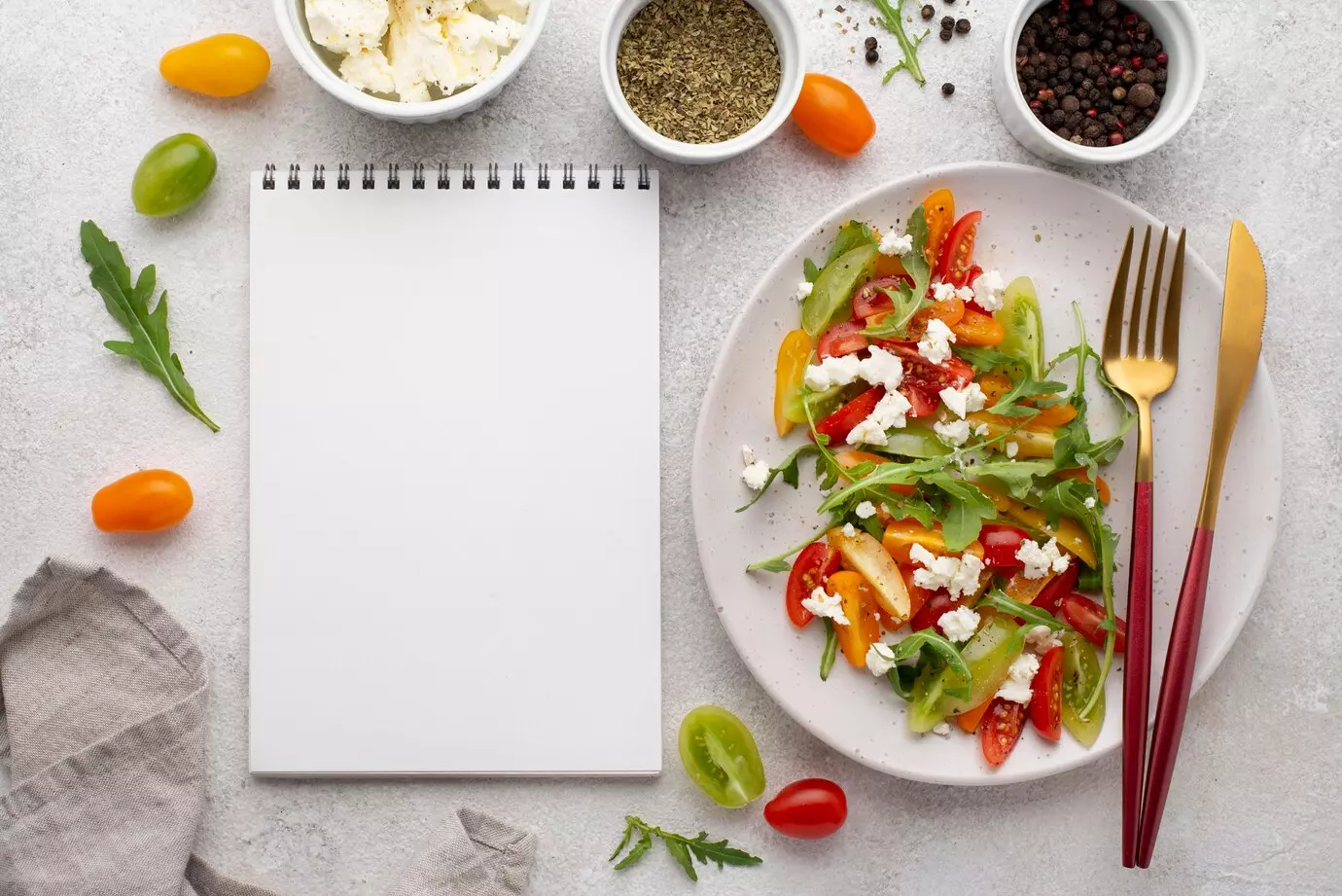 top-view-tomato-mix-salad-with-feta-cheese-rucola-blank-notebook_23-2148700394