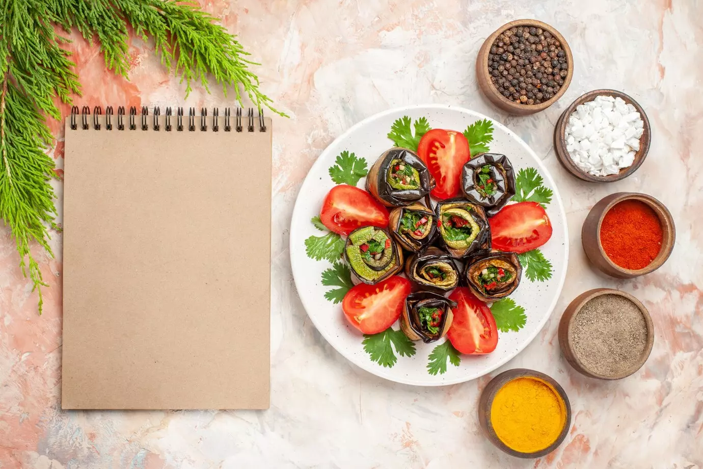 top-view-yummy-eggplant-rolls-with-greens-tomatoes_140725-135230